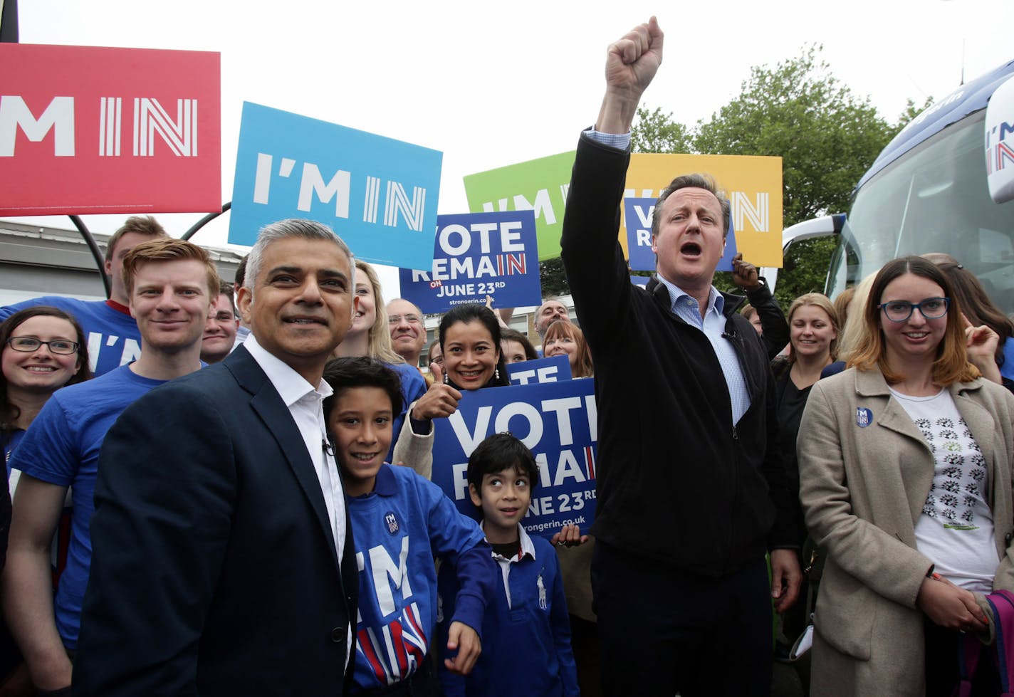 Britain's Prime Minister David Cameron, center right, makes a joint appearance for the Remain campaign with Mayor of London Sadiq Khan, in London, Monday, May 30, 2016. Campaigning is intensifying ahead of the June 23 in-out referendum with Cameron's Conservatives badly split over the issue of Europe. He is opposed by several Cabinet members who favor leaving the EU. Khan joins Cameron on a "Britain Stronger in Europe" bus trip, saying the issue is more important than political differences betwe