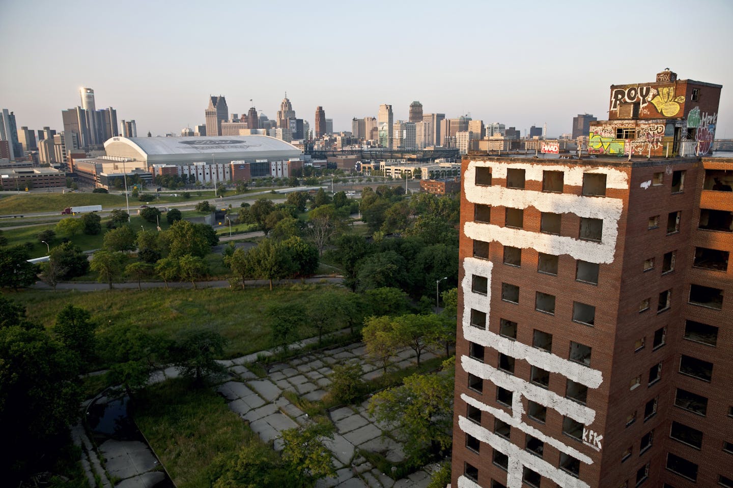 Graffiti-covered buildings stand in the foreground of an overview of downtown Detroit the morning after the city filed for bankruptcy.