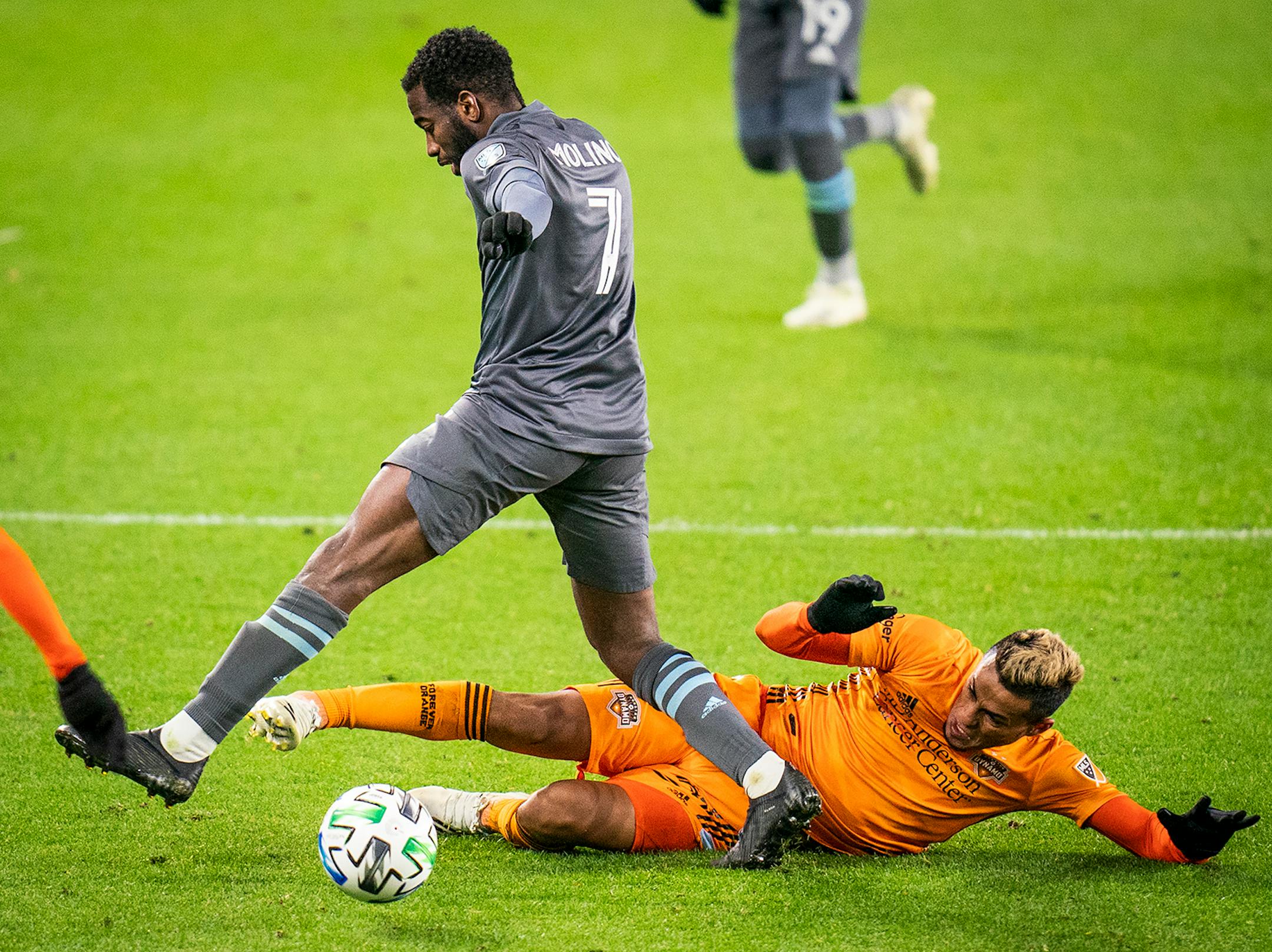 Minnesota United midfielder Kevin Molino (7) and Houston Dynamo midfielder Darwin Ceren (24) collided during the second half.