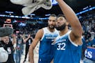 Minnesota Timberwolves center Rudy Gobert (27) and Minnesota Timberwolves center Karl-Anthony Towns (32) wave to the crowd after defeating the Atlanta