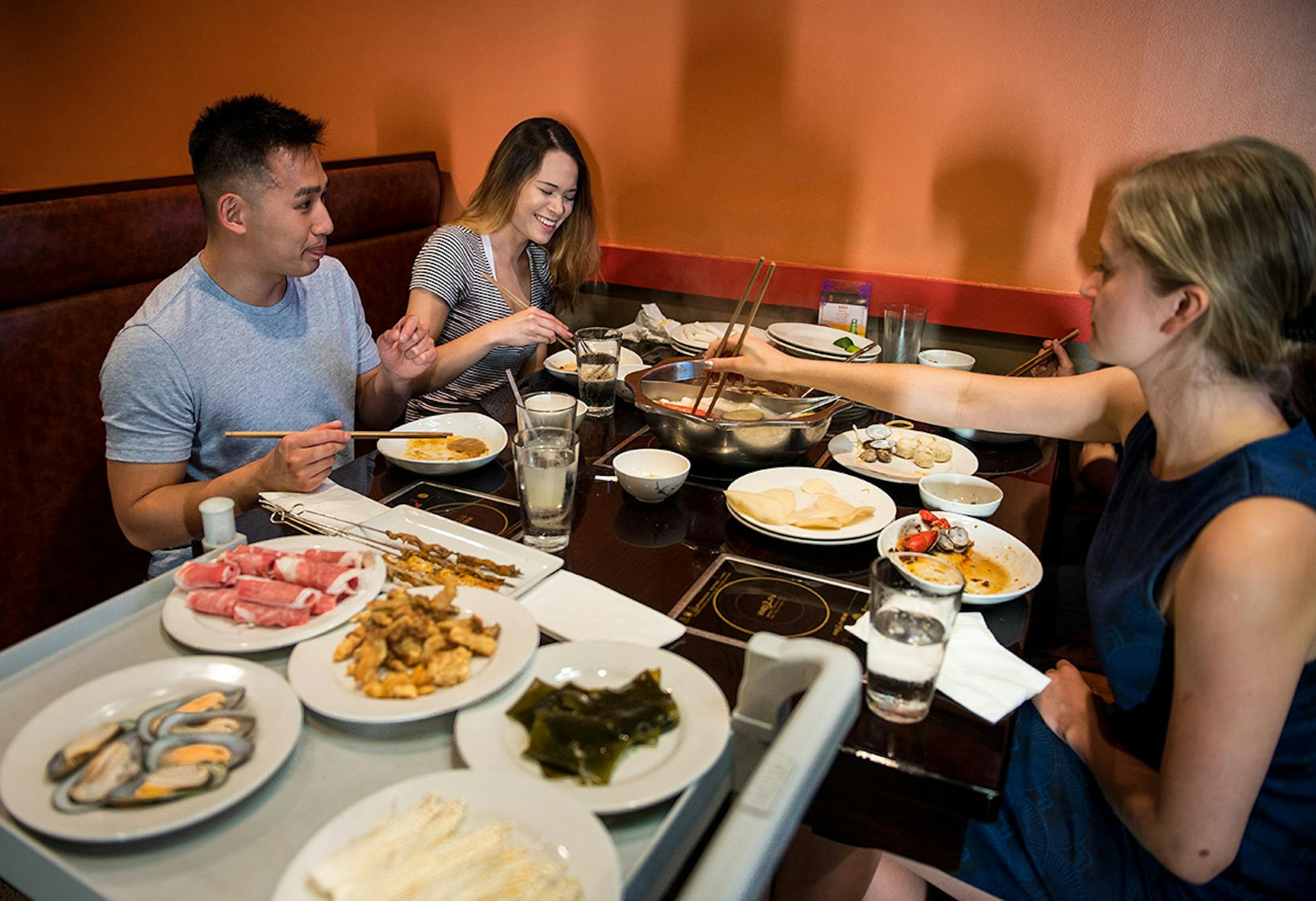 From left, Charles Litecky (CQ), of Lakeville, Amelia Anderson (CQ), of Coon Rapids, Brooke Schooler (CQ), of Carver and Michue Thao (CQ), not pictured, of Maplewood, dined at Little Szechuan Hot Pot Wednesday night in St. Paul.