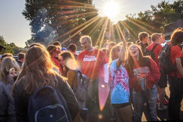 Minnehaha Upper School seniors and some staff members gathered in the parking lot before the first day of school.