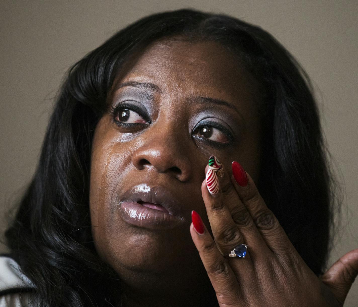 Naomi Davis cries while talking about all the stress her former job gave her inside her Minneapolis home on Thursday, December 17, 2015. ] (Leila Navidi/Star Tribune) leila.navidi@startribune.com BACKGROUND INFORMATION: Naomi Davis said she felt "sick to her stomach" when her former employer, Complementary Support Services (CSS), asked her to falsify documents, violating the law. A mother of five children, Davis said the mental health provider, which is now being sued for fraud by the feds, woul