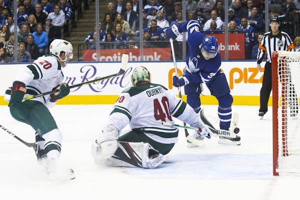 The Maple Leafs' Auston Matthews, right, scored on Wild goaltender Devan Dubnyk during Toronto's four-goal second period Tuesday.