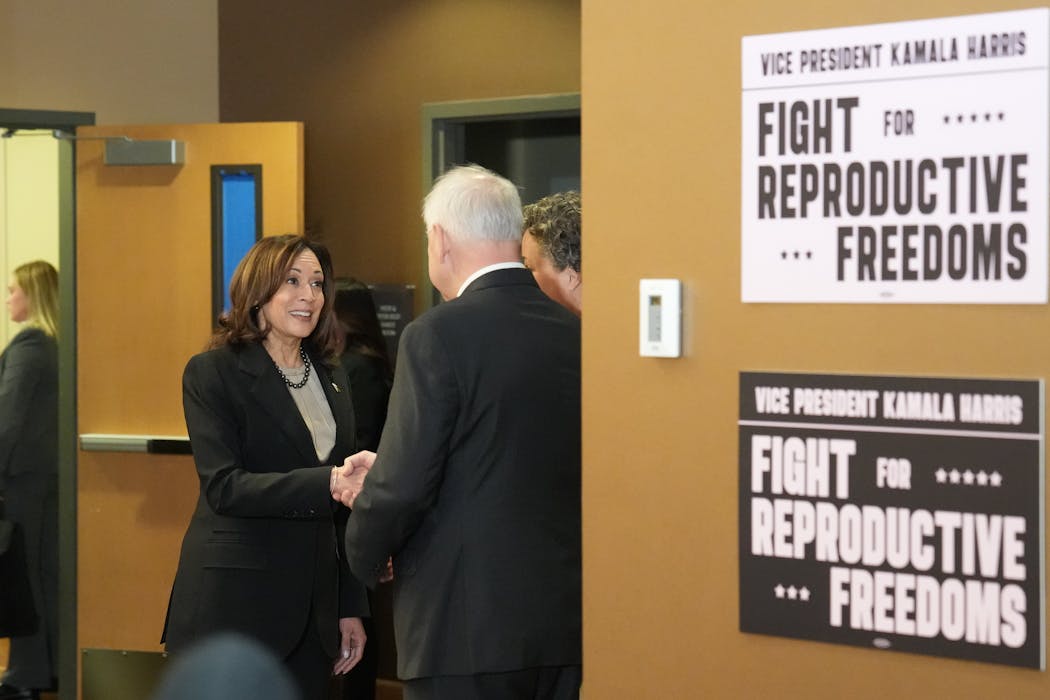 Vice President Kamala Harris greets Gov. Tim Walz on Thursday at the  Planned Parenthood clinic in St. Paul.