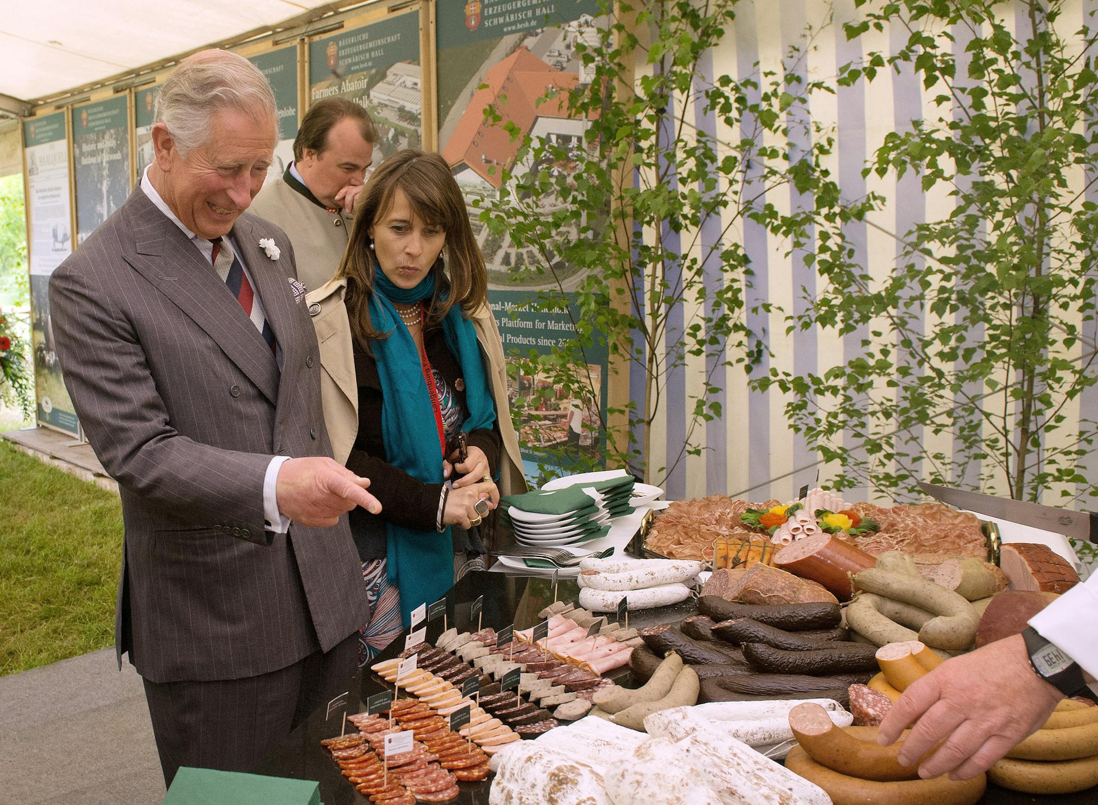 Britain's Prince Charles views meat products as he stands next to Princess Xenia of Hohenlohe-Langenburg , right, and Philipp, Prince of Hohenlohe-Langenburg, back, in Croeffelbach, Germany, Monday May 27, 2013. Prince Charles is visiting Langenburg Castle to take part in a symposium on regional food production (AP Photo/dpa, Marijan Murat)