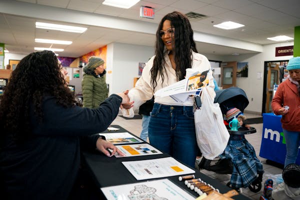 Patricia Rodriguez learns about various career opportunities at a job fair at the CareerForce Center on Wednesday in Minneapolis. The state reported T