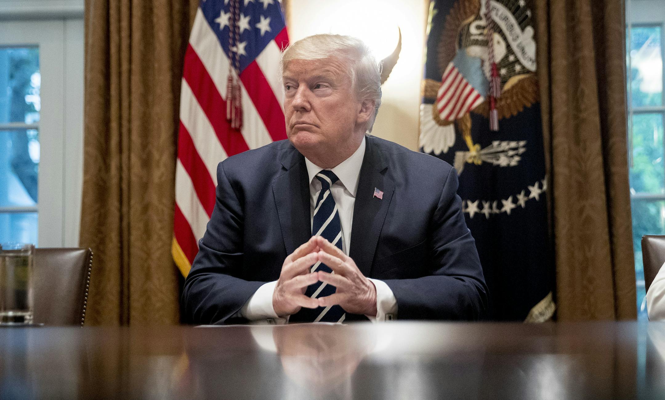 President Donald Trump waits for members of the media get set up before speaking in the Cabinet room of the White House, Tuesday, July 17, 2018, in Washington. Trump says he meant the opposite when he said in Helsinki that he doesn't see why Russia would have interfered in the 2016 U.S. elections.. (AP Photo/Andrew Harnik)
