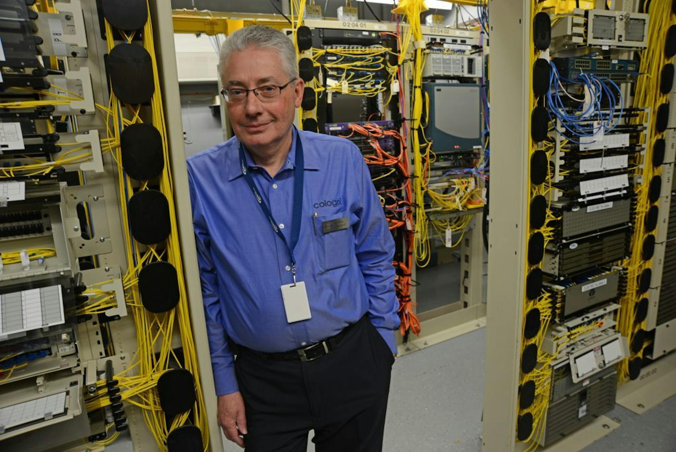 Cologix is an Internet access firm doing business in the 511 building, the most Internet-connected structure in Minnesota (it has multiple pathways to the Internet. Mike Hemphill is General Manager of the Minnesota Gateway for Cologix. In this picture he is standing in a area of yellow fiber cable connections