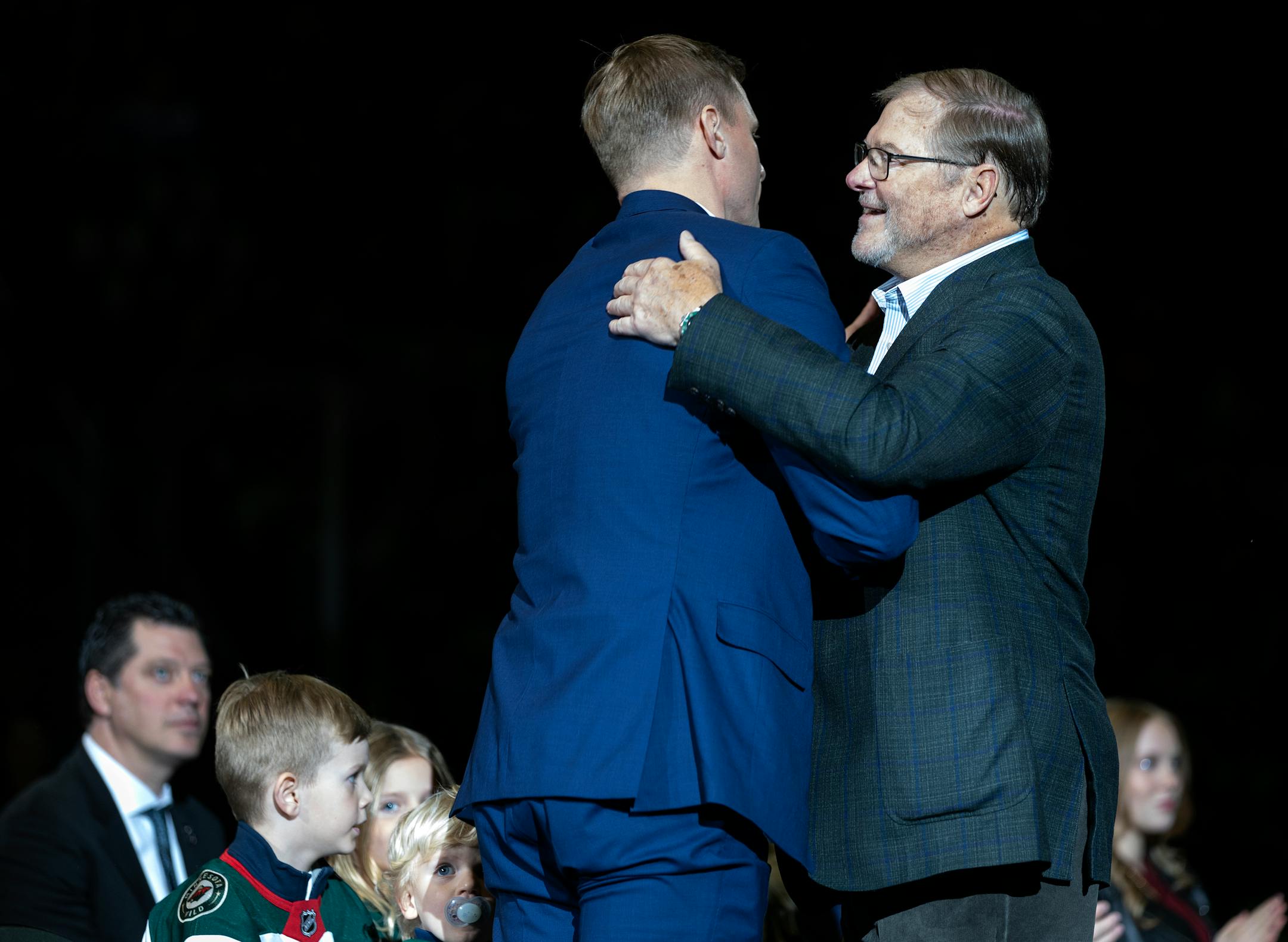 Mikko Koivu gets a hug from Minnesota Wild owner Craig Leipold during a ceremony to retire his number.