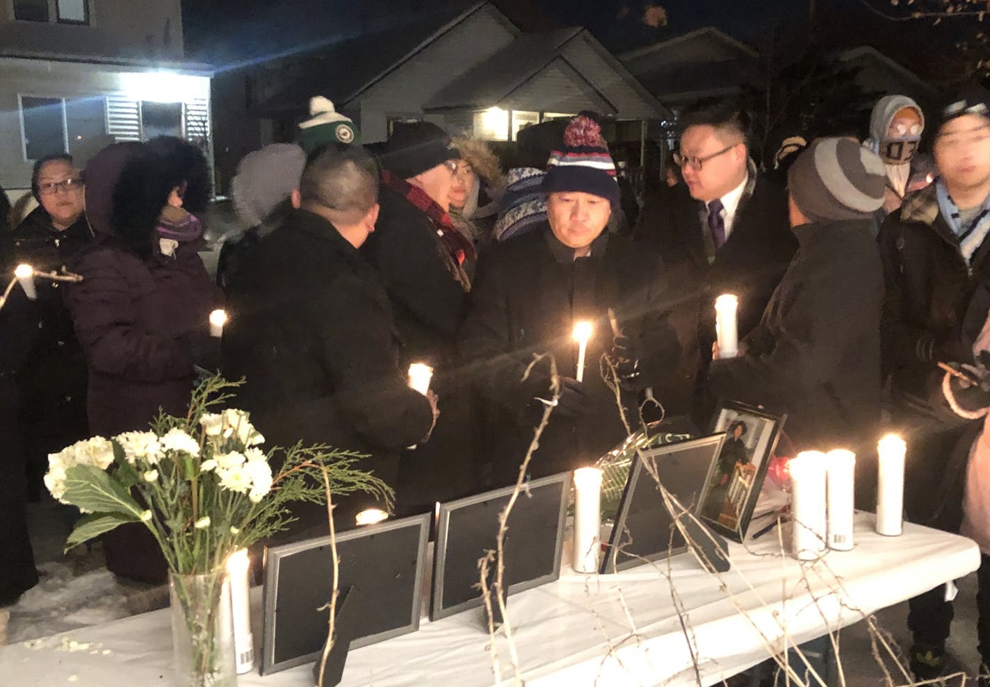 Several dozen people attended a candlelight vigil on Dec. 17, 2019, outside the home of Chiasher Fong Vue, who was shot and killed by Minneapolis police on Dec. 15 following an armed confrontation.