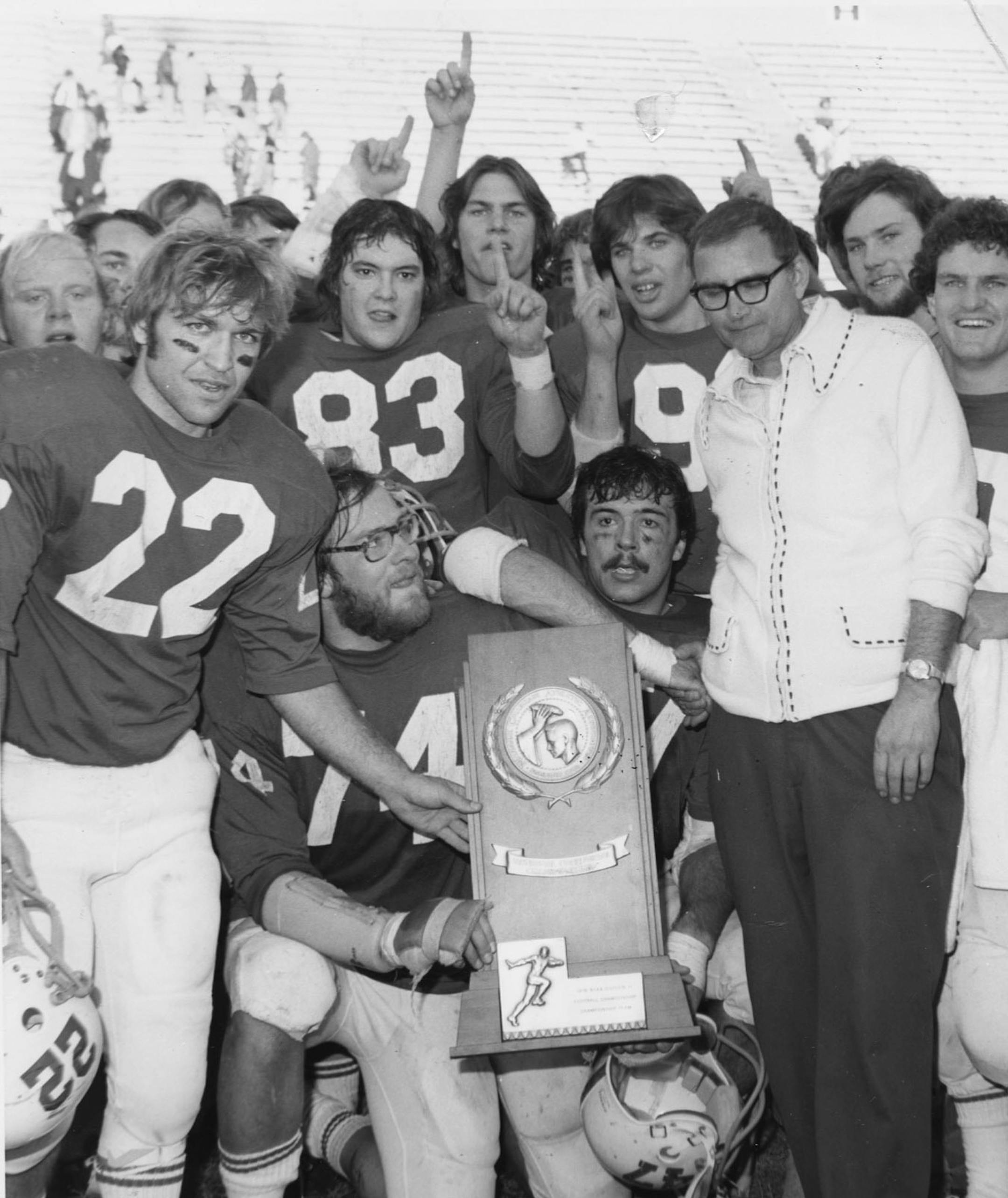 John Gagliardi posed with the Johnnies after winning the 1976 Division III national championship.