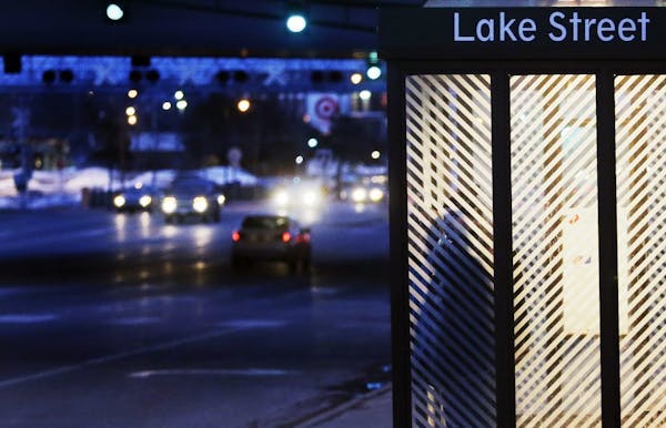 A commuter waits in a bus shelter at the Lake Street/Midtown Metro Station Friday, March 28, 2014, in Minneapolis, MN.