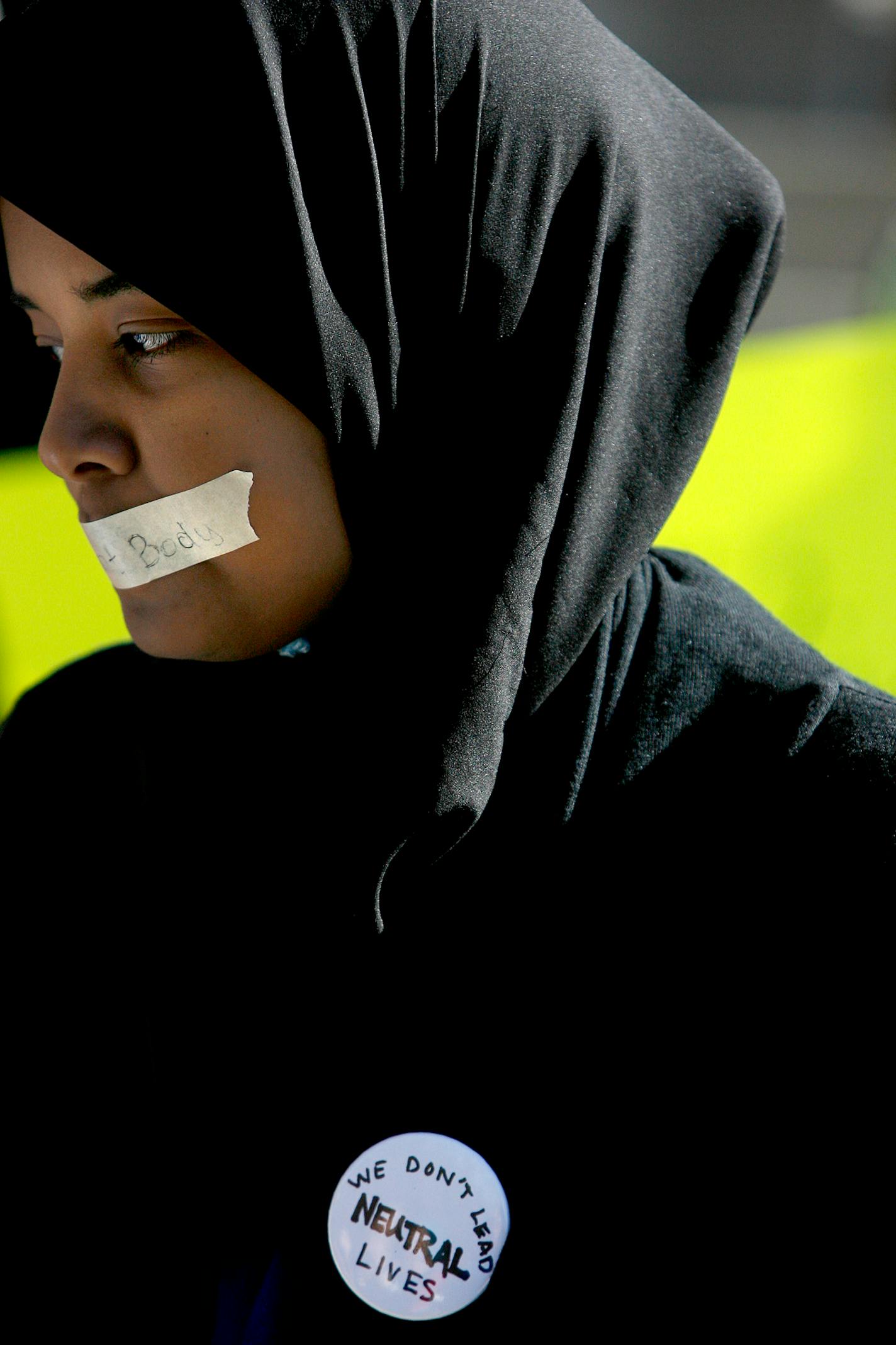 Dol Hassan protested the school's policy on political speakers at the College of St. Catherine by putting duct tape on her mouth. She and other students protested in front of Derham Hall.