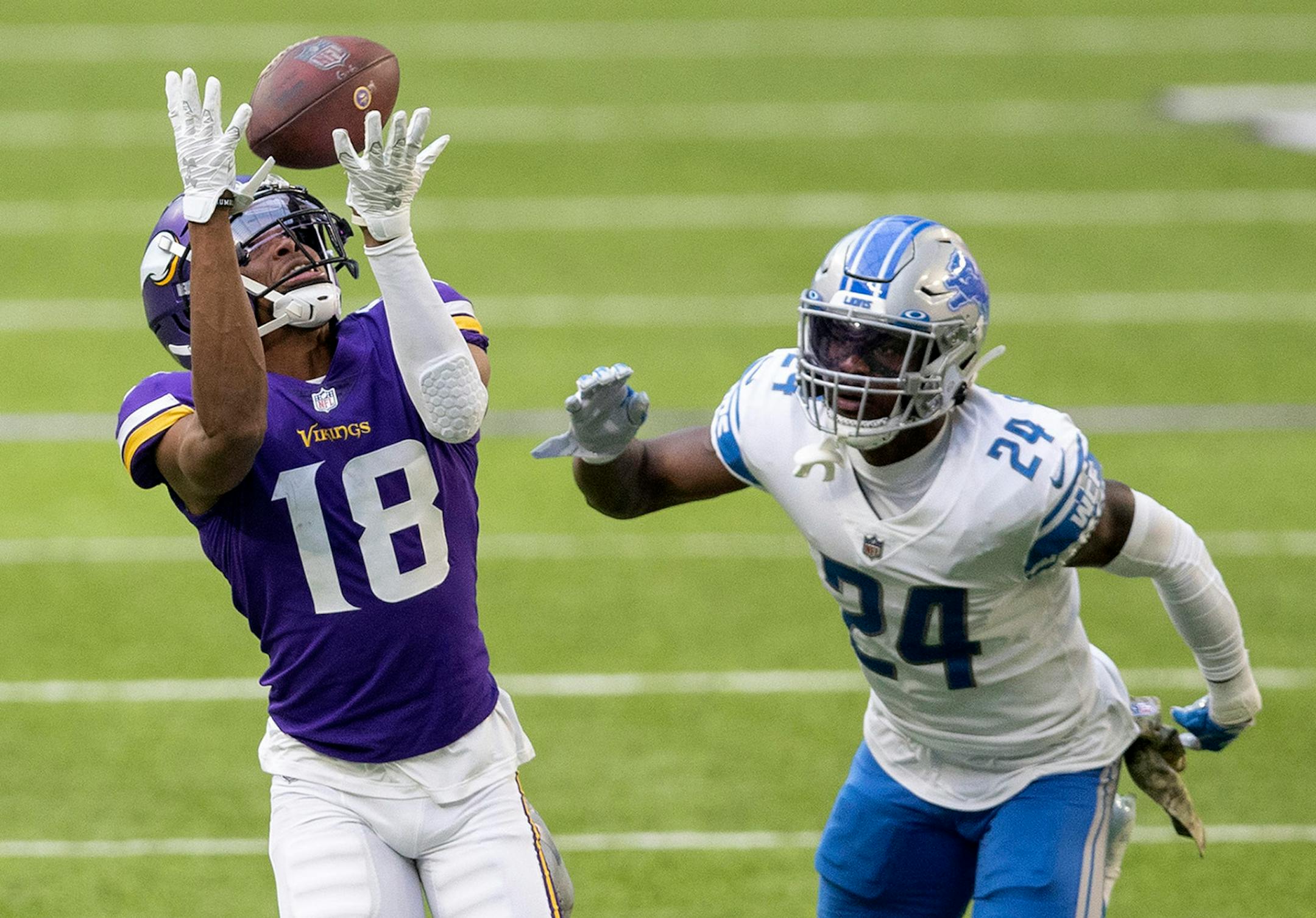 Minnesota Vikings wide receiver Justin Jefferson (18) caught a deep pass over Detroit Lions cornerback Amani Oruwariye (24) in the third quarter.