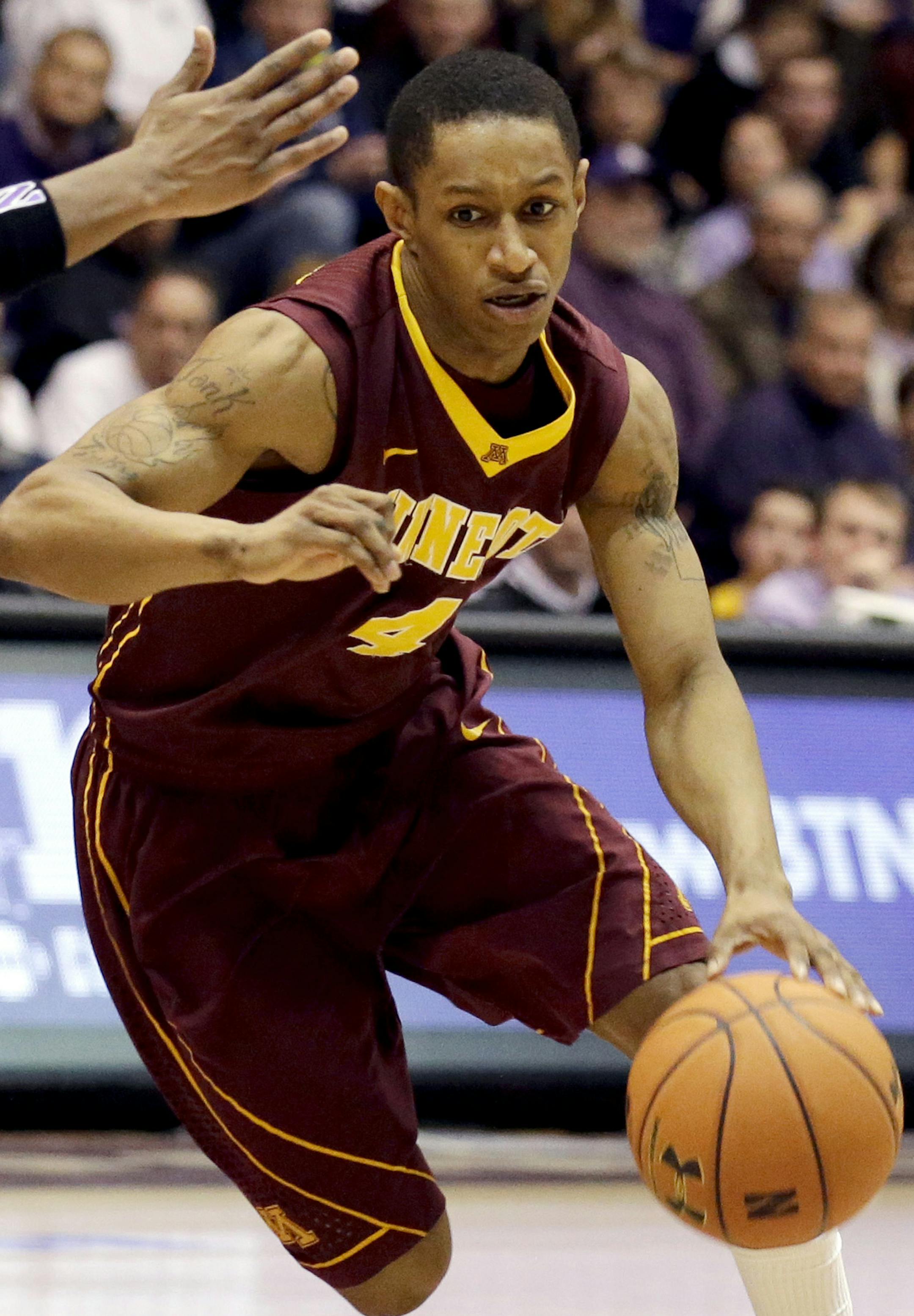 Minnesota guard DeAndre Mathieu, right, drives against Northwestern guard JerShon Cobb during the first half of an NCAA college basketball game in Evanston, Ill., Sunday, Feb. 16, 2014. (AP Photo/Nam Y. Huh)