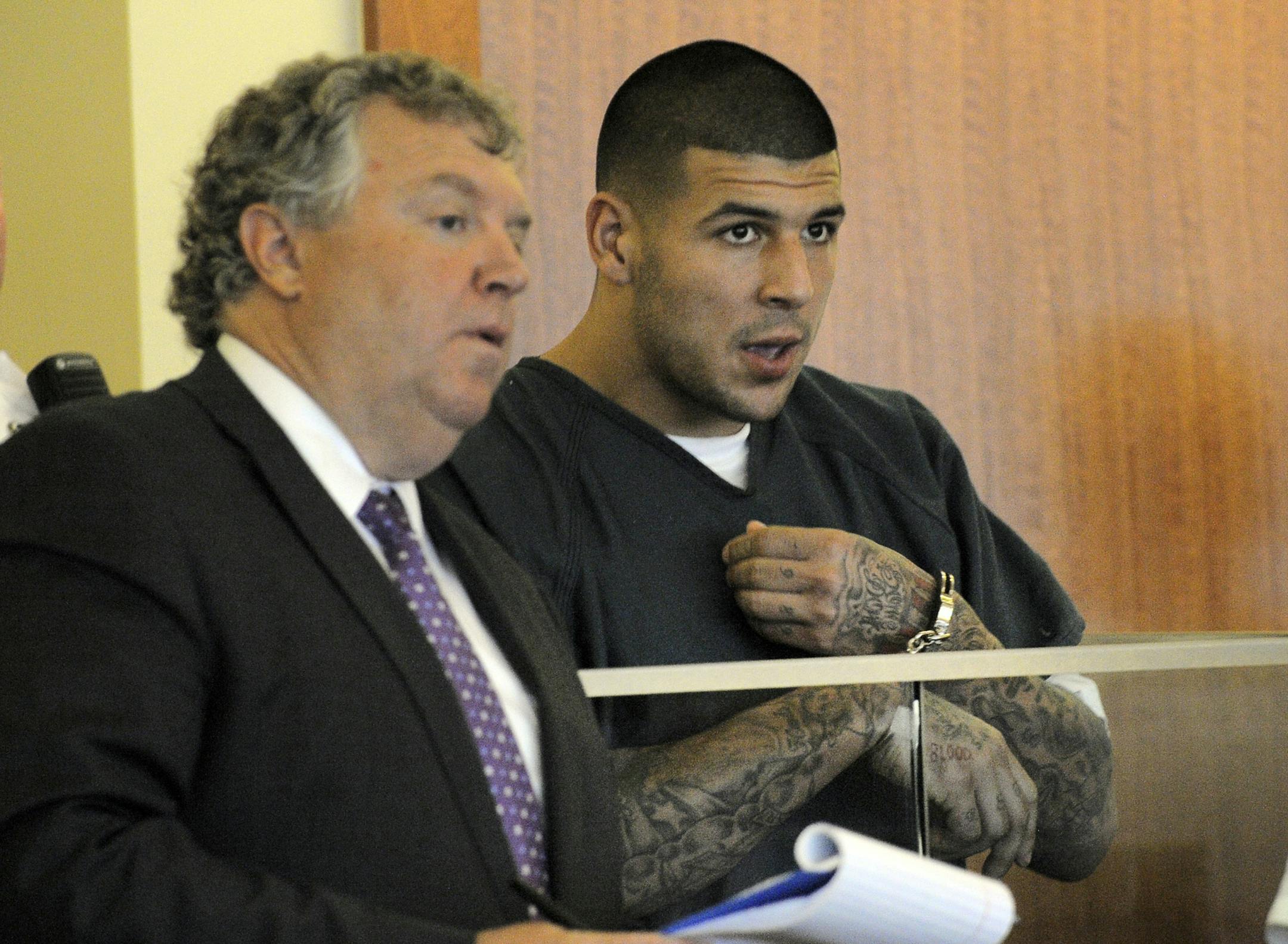 Former New England Patriots football player Aaron Hernandez, right, stands with his attorney Michael Fee, during a bail hearing in Fall River Superior Court Thursday, June 27, 2013, in Fall River, Mass. Hernandez, charged with murdering Odin Lloyd, a 27-year-old semi-pro football player, was denied bail.
