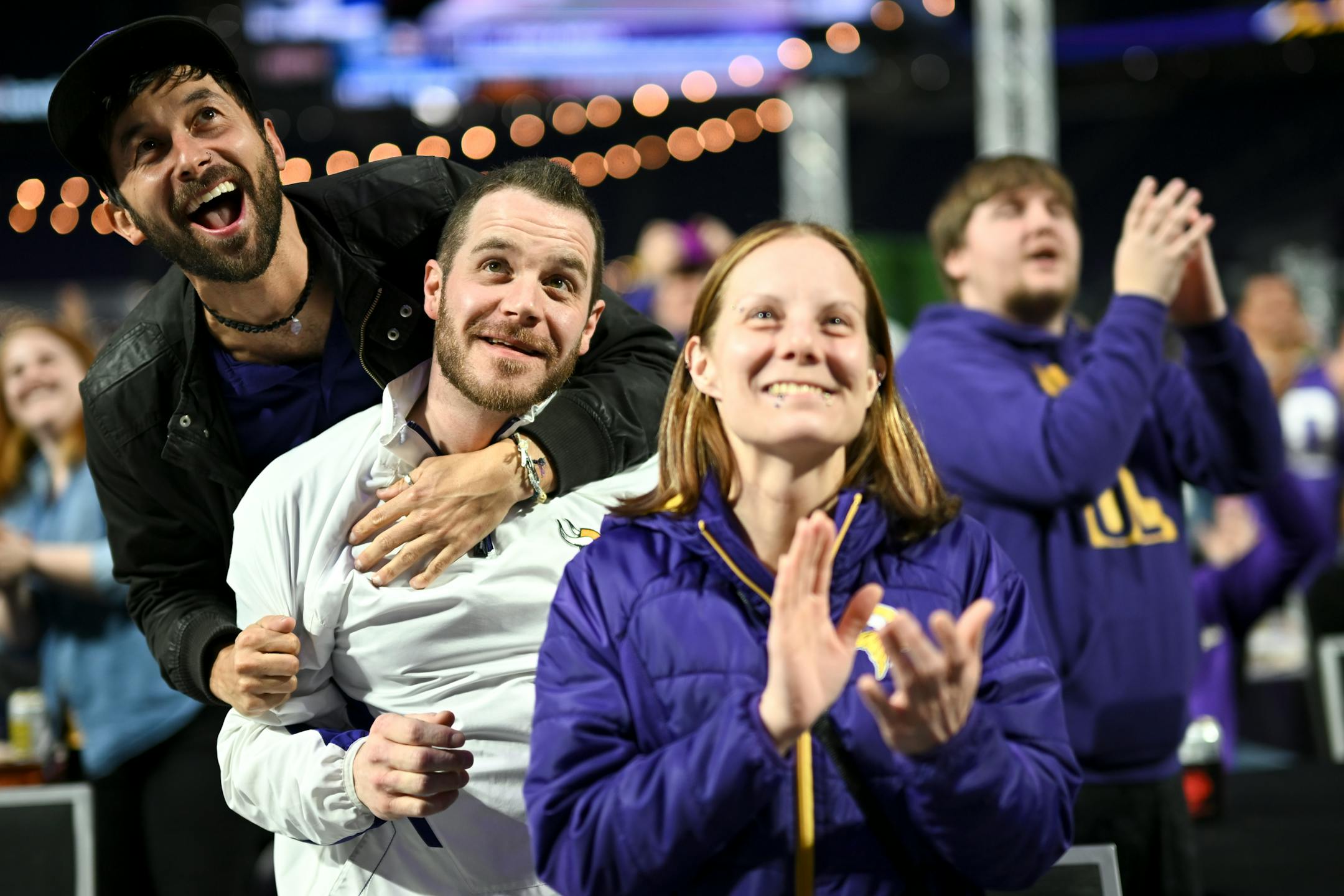 David LeDuc, left, of Robbinsdale, celebrates with his cousin, Paul Haataja, of Isanti, after the Vikings selected USC wide receiver Jordan Addison in the first round during the Vikings NFL Draft Party Thursday night at U.S. Bank Stadium in Minneapolis.