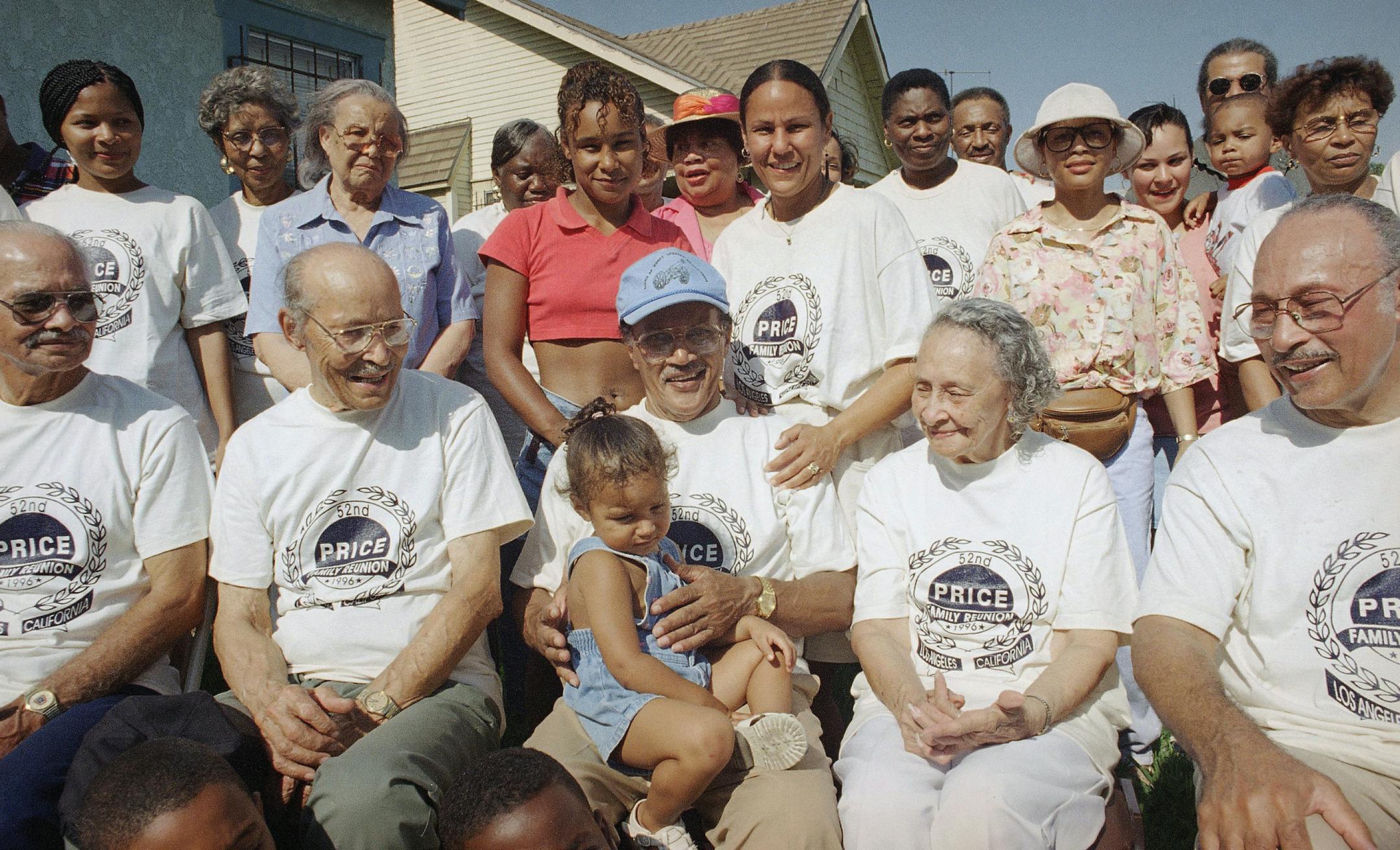 Herbert Price, center, holds his great-granddaughter Karina Wheeldin as he and several Price family members pose for a photo, on Friday, July 26, 1996 in Los Angeles. The Price family was on hand for their 52nd family reunion. (AP Photo/Michael Tweed) ORG XMIT: APHS253425