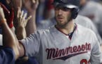Minnesota Twins' Mitch Garver is congratulated by teammates after Garver hit a three-run home run off Cleveland Indians starting pitcher Carlos Carras