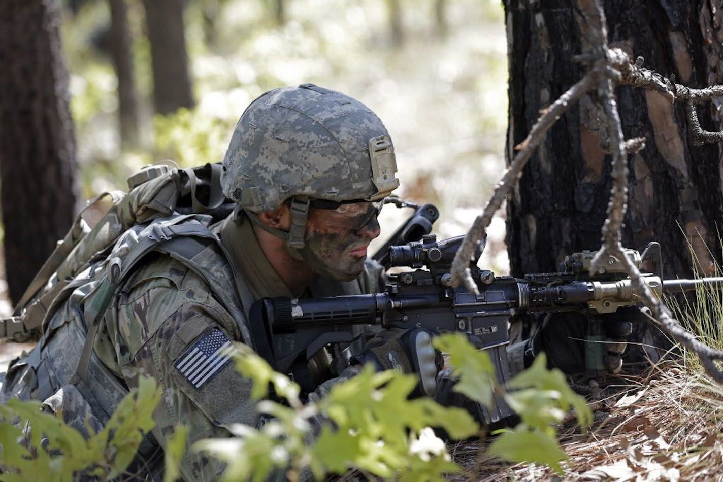 In this photo taken Friday, April 21, 2017, a paratrooper with the 82nd Airborne Division's 3rd Brigade Combat Team participates in a training exercise at Fort Bragg, N.C. Struggling to expand its ranks, the Army will triple the amount of bonuses it�s paying this year to more than $380 million, including new incentives to woo reluctant soldiers to re-enlist, officials told The Associated Press. (AP Photo/Gerry Broome