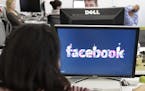 FILE -This Dec. 13, 2011 file photo, shows workers inside Facebook headquarters in Menlo Park, Calif. Facebook, the social network that changed "frien