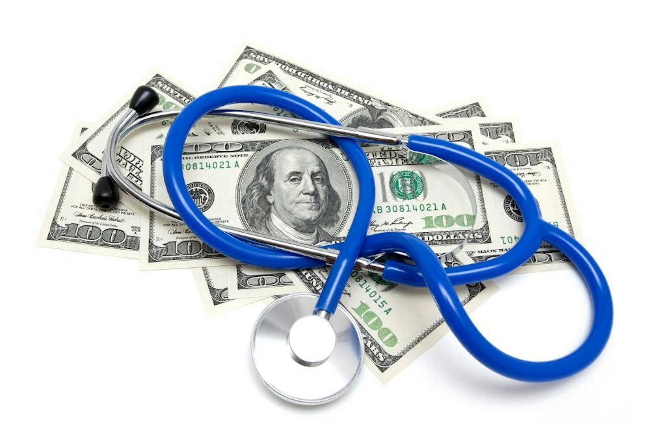 iStock Stethoscope on US dollars isolated on white background.