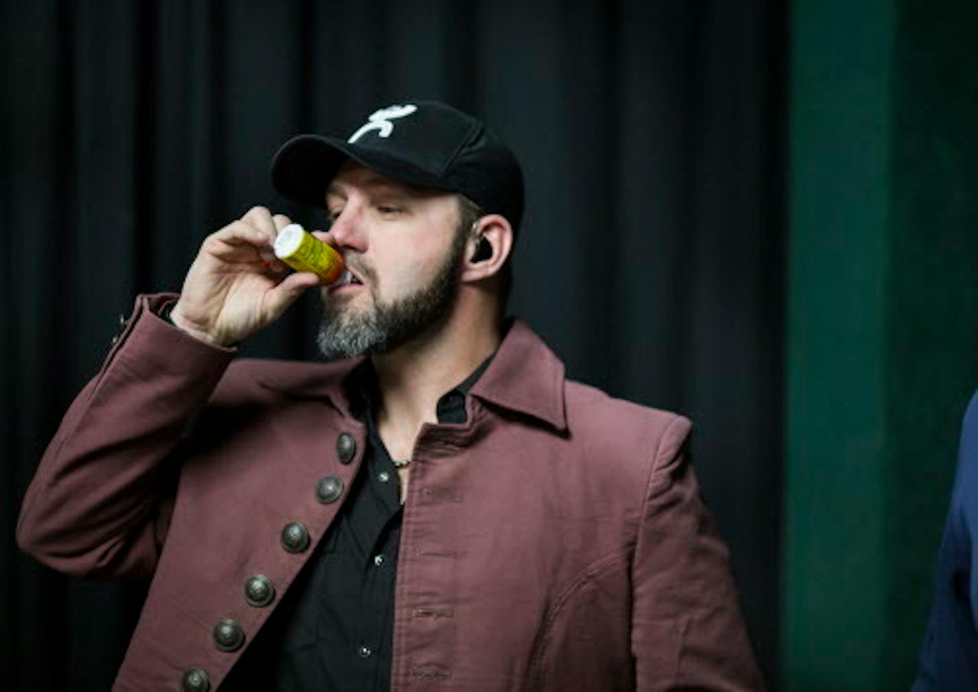 Chris Hawkey tipped back a 5 Hour Energy before performing as the opening act to the Gear Daddies at the Medina Entertainment Center in December.