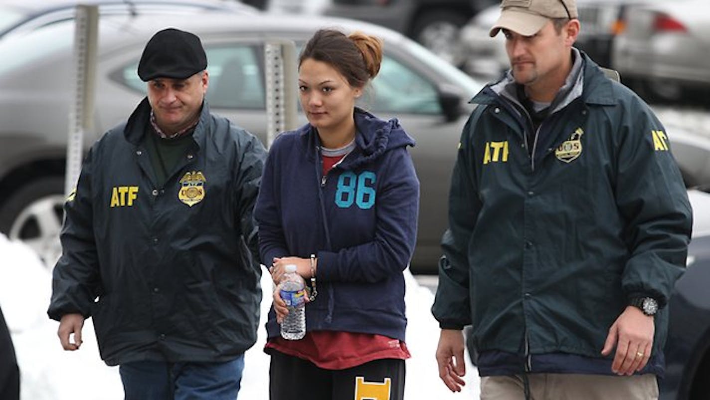 Dawn Nguyen is escorted into the Federal Building in Rochester and charged in connection with the guns used in the Christmas Eve 2012 ambush slaying of two volunteer firefighters responding to a house fire in Webster, in upstate New York.