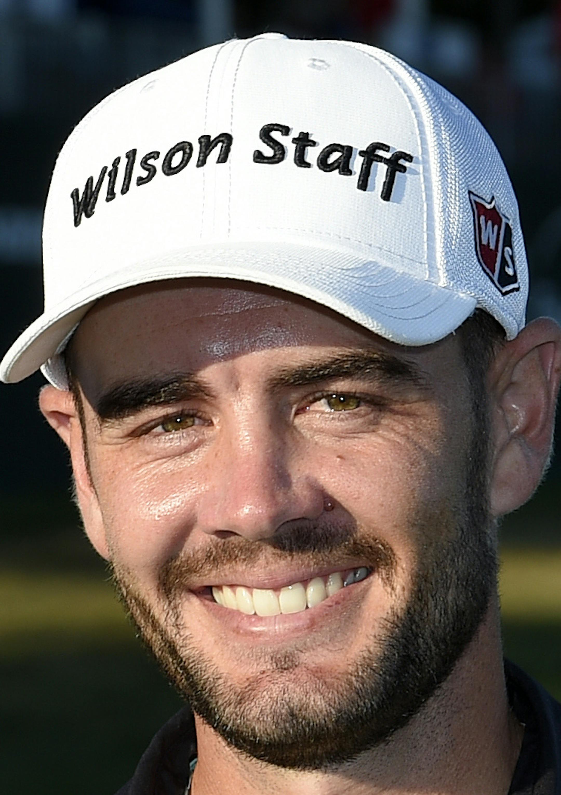 Troy Merritt poses with the trophy after he won the Quicken Loans National golf tournament at the Robert Trent Jones Golf Club in Gainesville, Va., Sunday, Aug. 2, 2015. (AP Photo/Nick Wass)