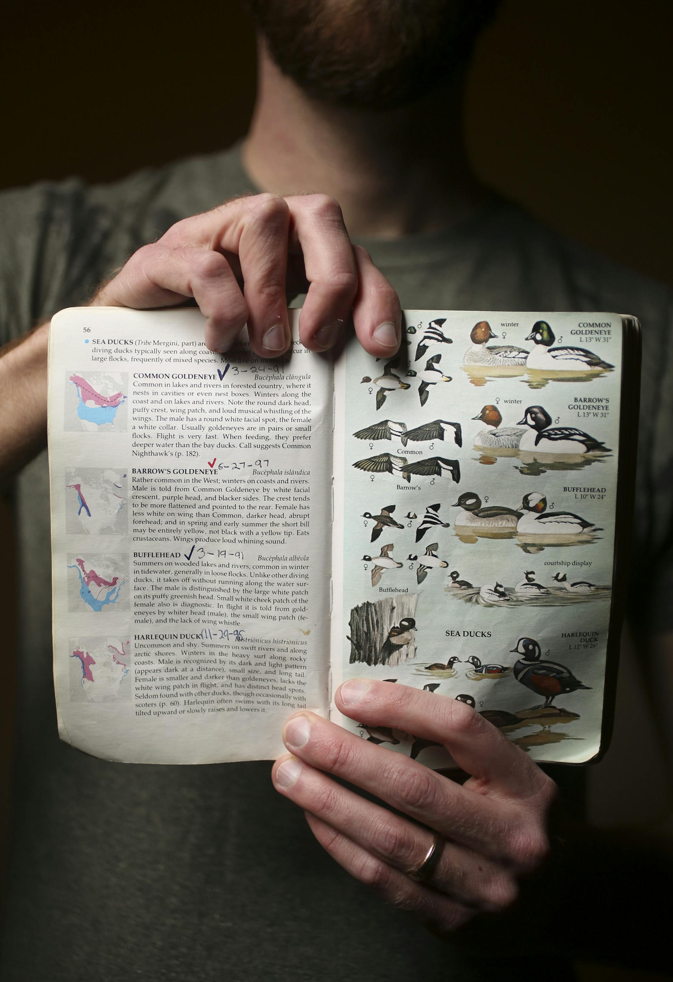 Bob Dunlap held the bird guide his parents gave to him when he was a boy that he credits with sparking his interest his hobby and career.