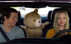 In this image released by Universal Pictures, Mark Wahlberg , from left, the character Ted, voiced by Seth MacFarlane, and Amanda Seyfried appear in a