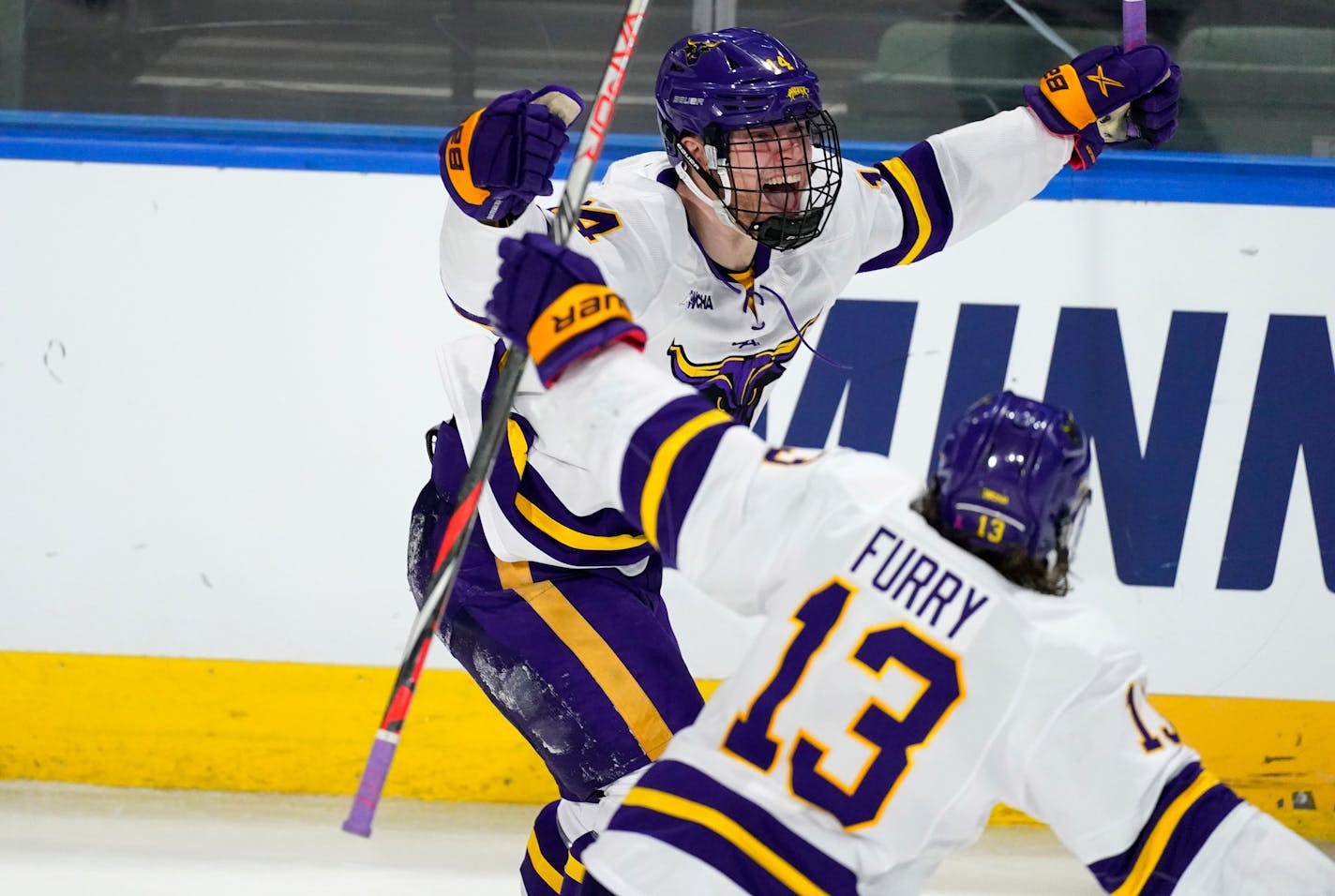 Minnesota State forward Ryan Sandelin, back, celebrates his overtime goal with forward Brendan Furry in the team's NCAA West Regional college hockey semifinal against Quinnipiac on Saturday, March 27, 2021, in Loveland, Colo. (AP Photo/David Zalubowski)