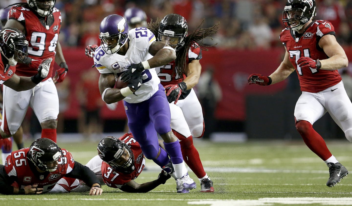 Minnesota Vikings running back Adrian Peterson (28) broke away from Atlanta defenders during a run in the third quarter.