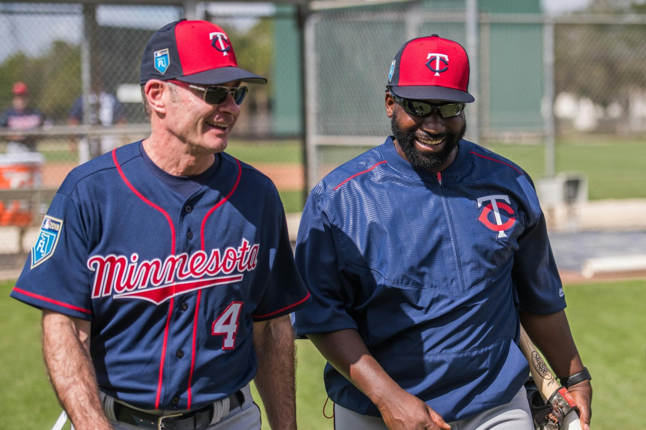Twins manager Paul Molitor and AA manager Tommy Watkins walk off the field after workouts.