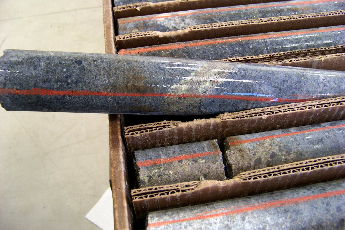 FILE - In this Oct. 4, 2011, file photo, a core sample drilled from underground rock near Ely, Minn., shows a band of shiny minerals containing copper, nickel and precious metals, center, that Twin Metals Minnesota LLC, hopes to mine near the Boundary Waters Canoe Area Wilderness in northeastern Minnesota. The Trump administration on Thursday, Sept. 6, 2018, lifted a roadblock to copper-nickel mining in the area saying its review revealed no new scientific information. It says companies may soon