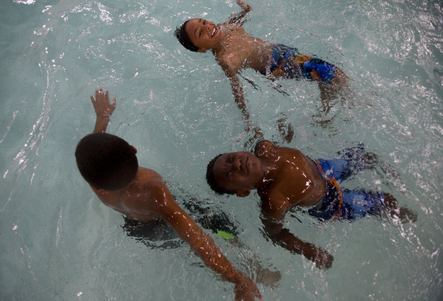 Swim students practice kicking while on their backs during lessons at the YMCA. ] ALEX KORMANN • alex.kormann@startribune.com Statistics show that children of color are at a greater risk of drowning than white children. However, there are multiple programs throughout Minnesota helping to combat the dangers of swimming. One of these programs is at the Blaisdell YMCA in Minneapolis where they introduce water safety and survival techniques into basic swim lessons.