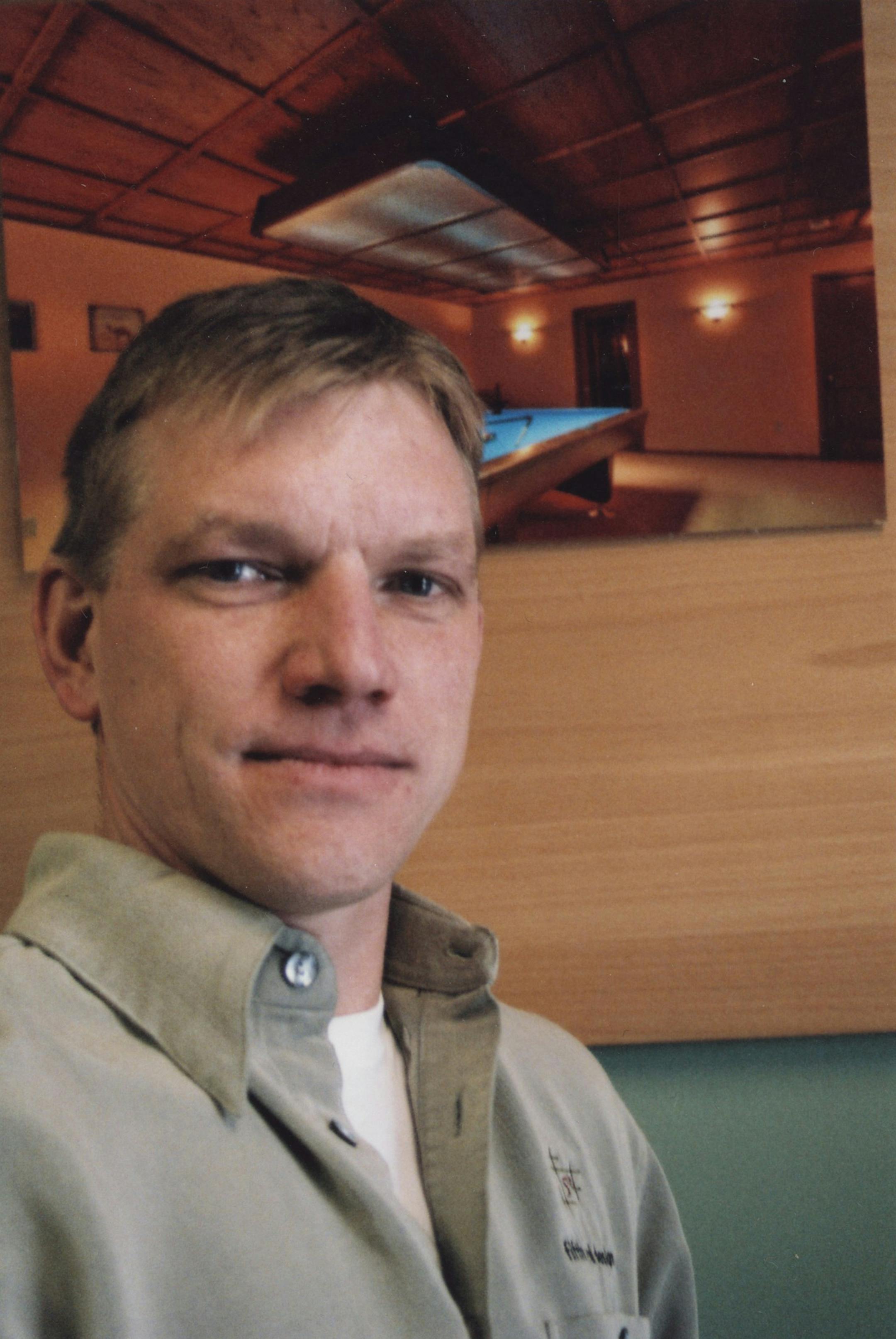 the photo behind Greg Moore shows off one of the customized wood ceilings his company, 5th wall designs, manufactures and finishes using upward of 80 different woods from around the world.