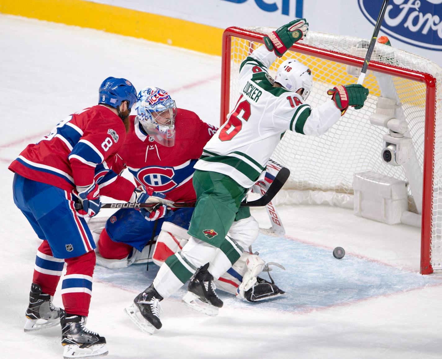 Minnesota Wild left wing Jason Zucker (16) celebrates after scoring as Montreal Canadiens goalie Charlie Lindgren (39) and defenseman Jordie Benn (8) watch during the third period of an NHL hockey game Thursday, Nov. 9, 2017, in Montreal. (Ryan Remiorz/The Canadian Press via AP)