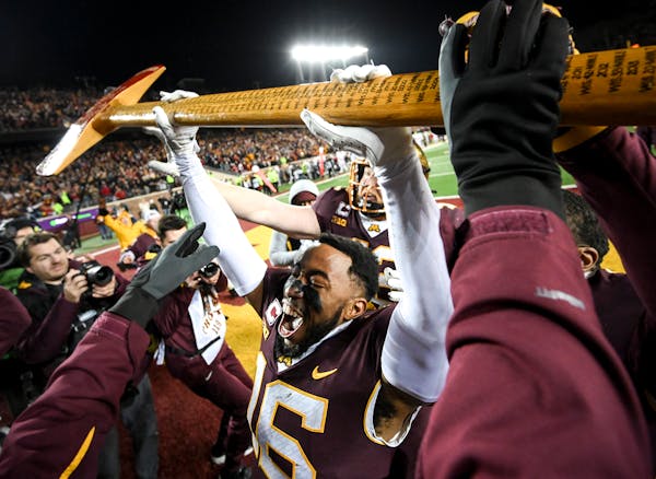Minnesota Gophers defensive back Coney Durr (16) takes control of Paul Bunyan’s Axe after an NCAA football game between the Gophers and the Wisconsi