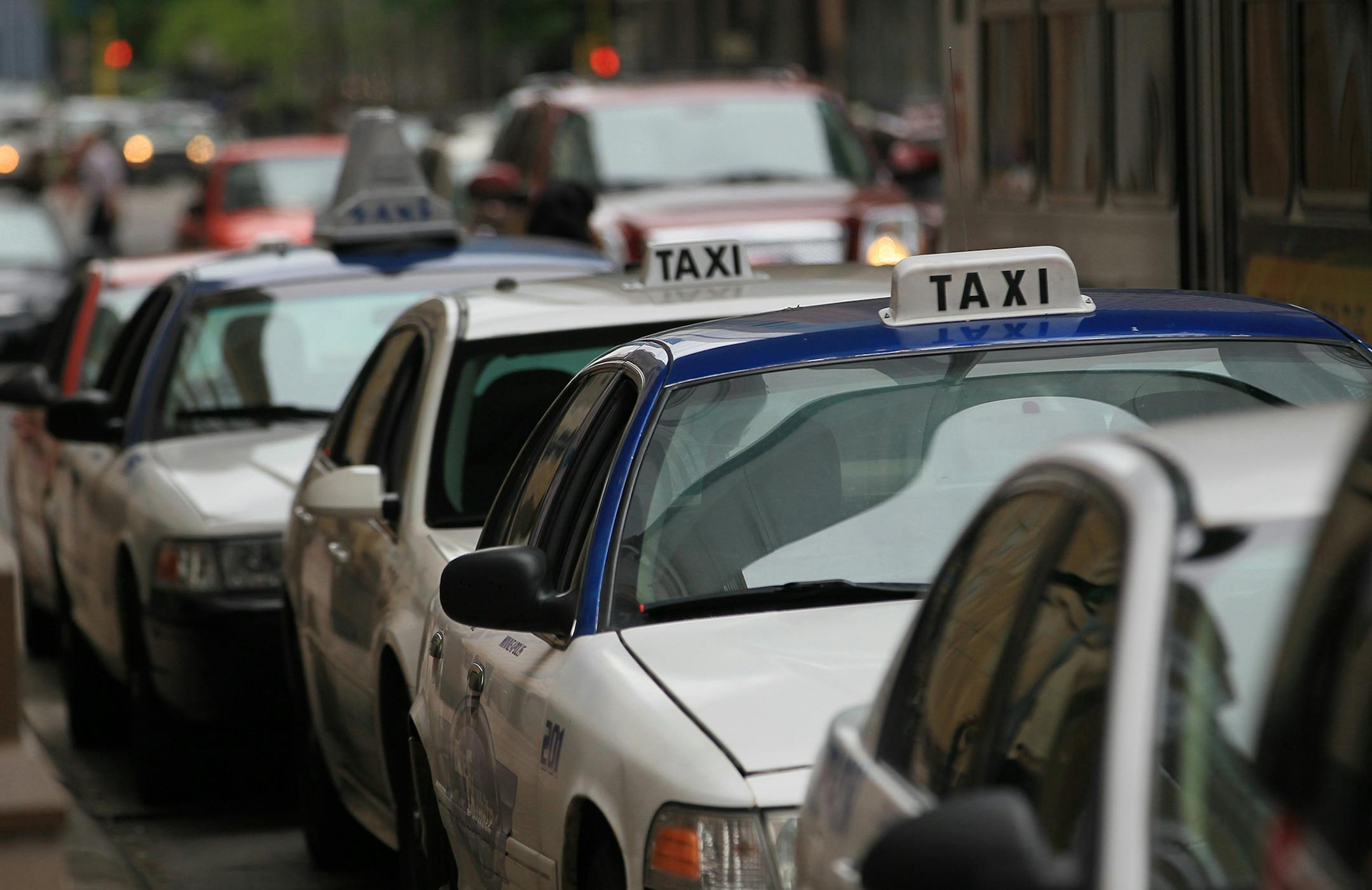 Taxi cabs lined the streets at taxi waiting areas in downtown Minneapolis on Friday, May 4, 2012 in Minneapolis, Minn. The number of cabs has doubled since 2007. ] (RENEE JONES SCHNEIDER/ reneejones@startribune.com) ORG XMIT: MIN2014070210270891