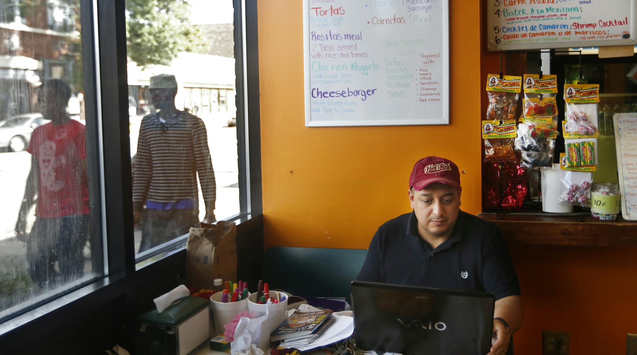 At Rosita's Barbacoa, owner Alberto Gasca worked on his computer as pedestrians went by his restaurant. He took over the restaurant from his brother in 2008 and has been in Willmar since 1999. Latino and East African immigrants have settled in Willmar, drawn to the western Minn. town by jobs at the Jennie-O turkey processing plant. But more and more, they've opened up businesses of their own and in the process, have changed downtown Willmar.] rtsong-taatarii@startribune.com, Alberto Gasca(cq)