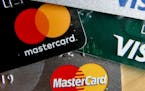 FILE - In this Feb. 20, 2019, file photo photo shows a logo for Mastercard on credit cards in Zelienople, Pa. Mastercard will allow transgender people