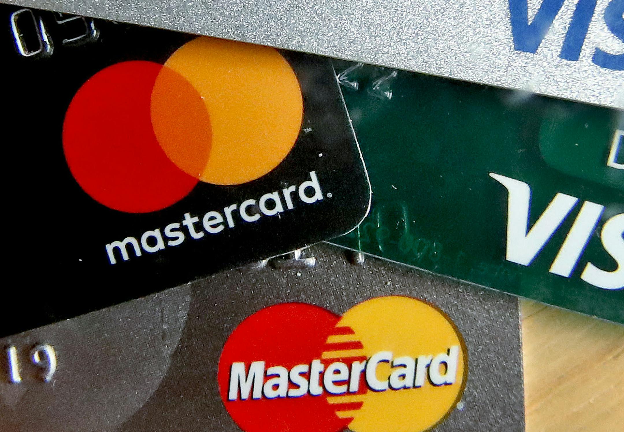 FILE - In this Feb. 20, 2019, file photo photo shows a logo for Mastercard on credit cards in Zelienople, Pa. Mastercard will allow transgender people to use their chosen names on credit cards in an effort to combat potential discrimination at the cash register. That means that the name on the credit card owned by a transgender person could be different than that found on their birth certificate or driver’s license. (AP Photo/Keith Srakocic, File)