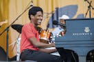 Jon Batiste performs during the Tribute to Fats Domino at the New Orleans Jazz and Heritage Festival on Saturday, April 28, 2018, in New Orleans. (Pho