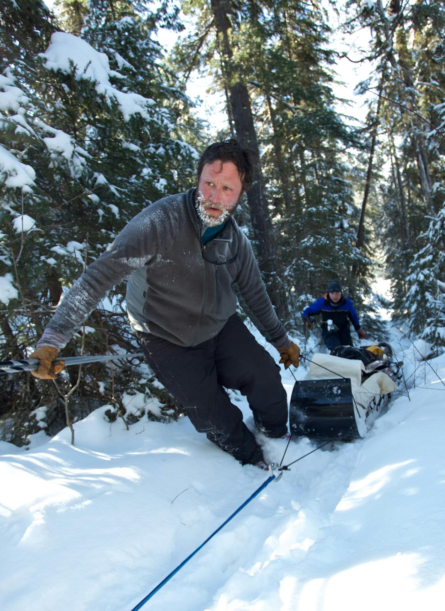 Dave helps the dogs across a hilly portage. Dave and Amy Freeman have a book documenting their year in the BWCA to raise awareness of mining's consequences.
Photo by Nate Ptacek