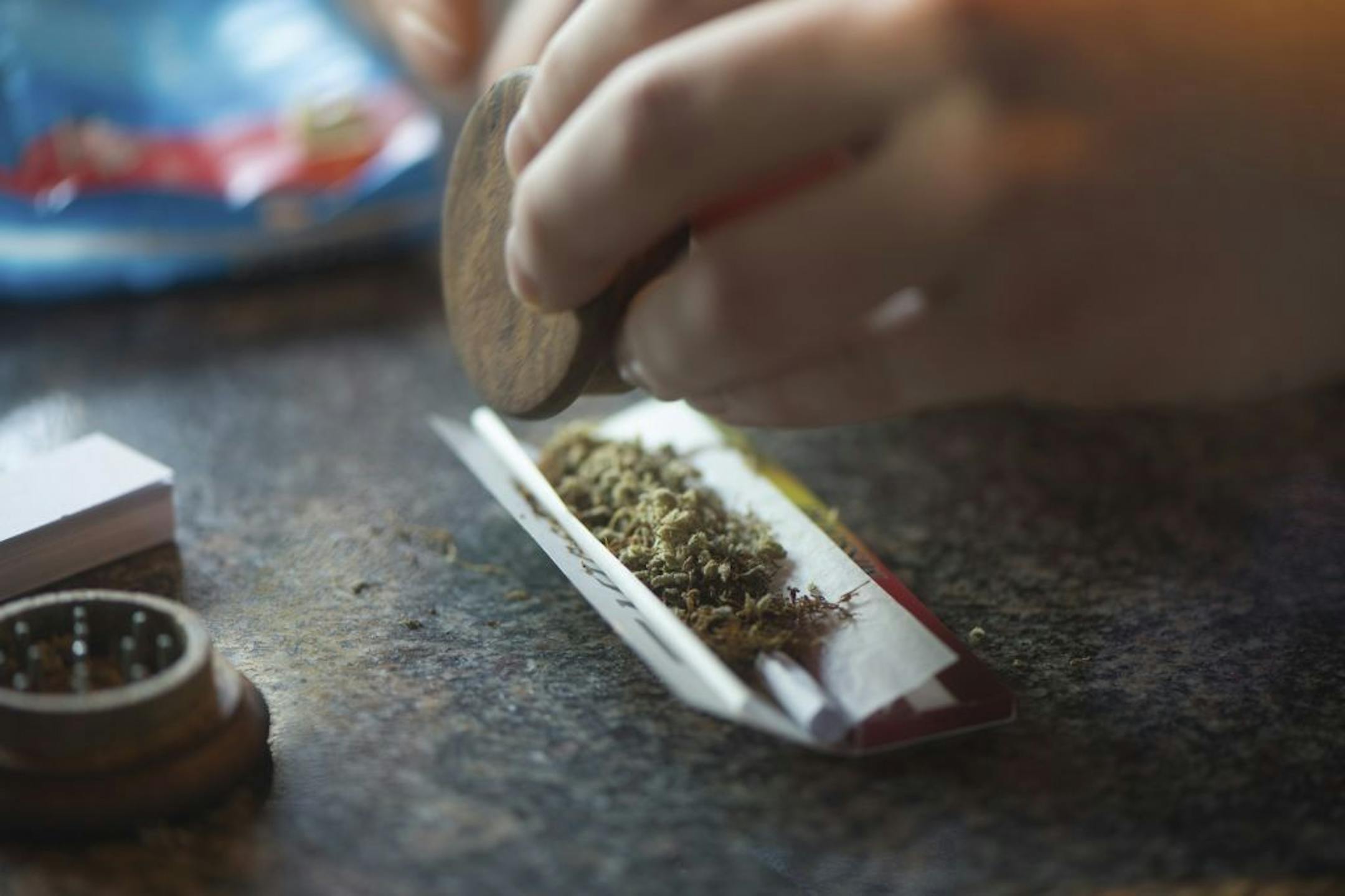 In this photo taken Friday, Dec. 20, 2013, a visitor rolls a marijuana joint in coffee shop Mississippi in Maastricht, southern Netherlands.