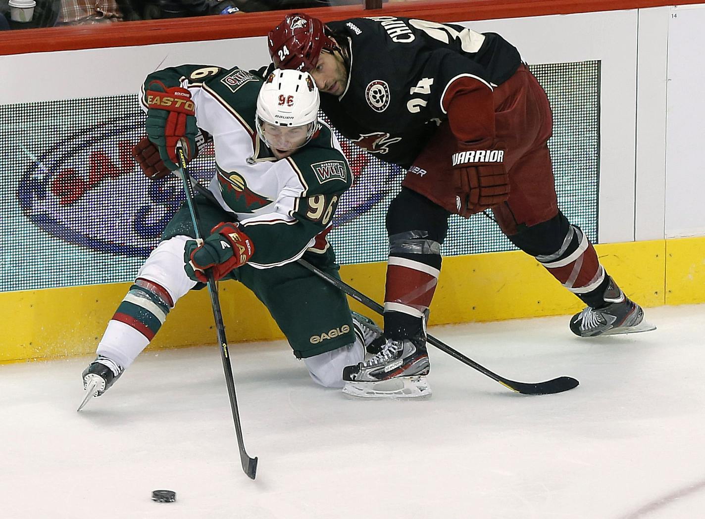 Minnesota Wild's Pierre-Marc Bouchard passes the puck as Phoenix Coyotes' Kyle Chipchura defends.