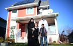 Sarah Olson, Mohamed Abdi and their two 7-year old children, Jamal and Sofia, were photographed in front of their Habitat for Humanity home of two yea