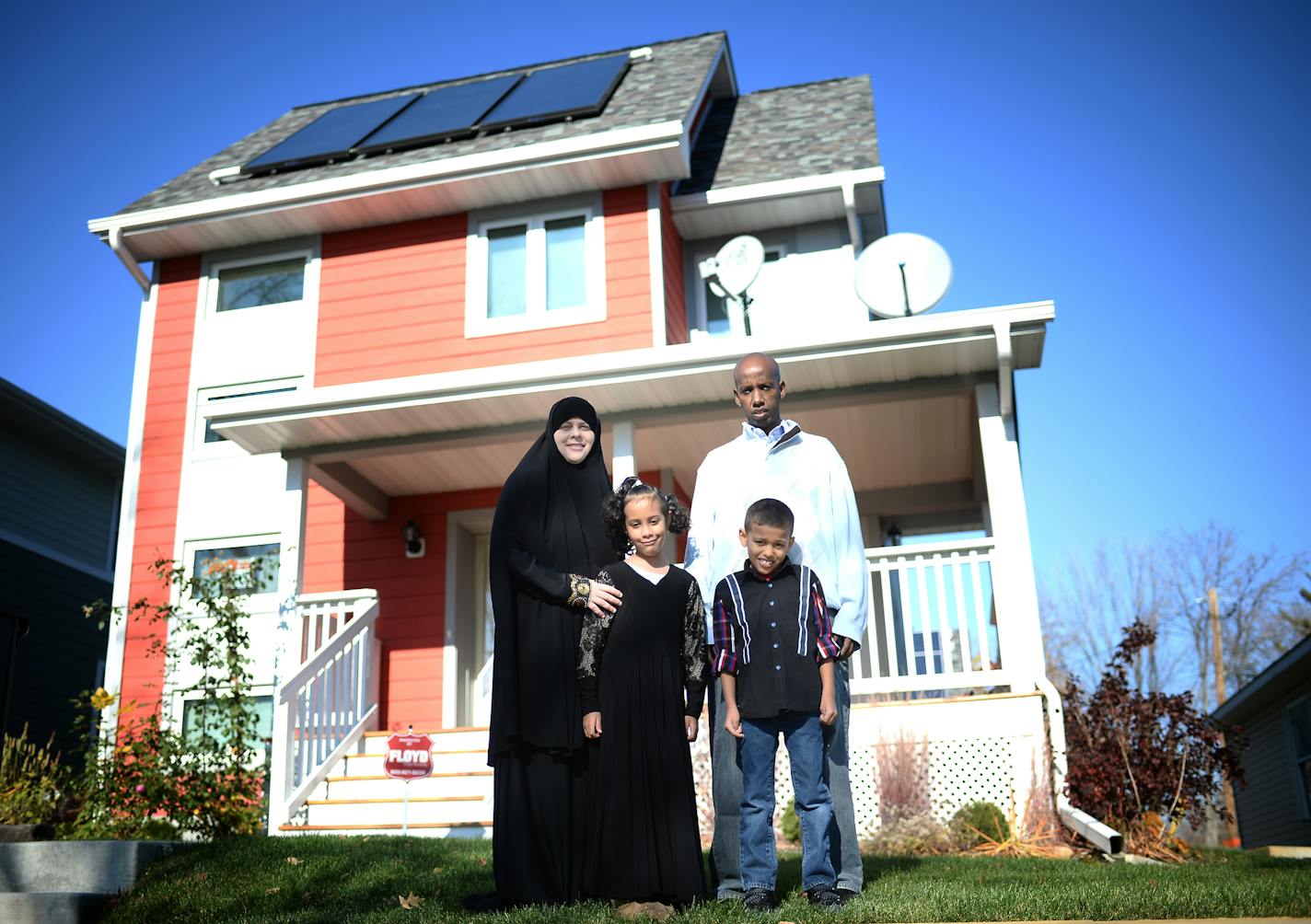 Sarah Olson, Mohamed Abdi and their two 7-year old children, Jamal and Sofia, were photographed in front of their Habitat for Humanity home of two years in North Minneapolis Saturday. ] (AARON LAVINSKY/STAR TRIBUNE) aaron.lavinsky@startribune.com A newly released study by the Wilder Foundation of families that have moved into Habitat for Humanity homes reads like a litany of good news. Habitat families report a host of positive impacts from their move. More than half say their kids are doing bet